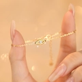 Elegante bracciale Evil Eye in argento S925 dorato con zircone sul polso di una donna - Argento 925 / Oro