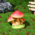 Three red spotted resin mushroom figurines on a green moss base for micro landscapes - Style F (Red & White Spots)