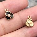 DIY flower pendants in black enamel and gold finish held to show small scale - 1Pc Black Pearl Three-Petal Flower 9x11.6mm
