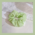 Pale green scrunchie in textured seersucker fabric on a marble surface background - 1043I Light Green Puff Gauze Texture