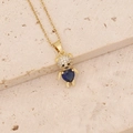 Detailed close-up of a gold bear pendant with a blue heart-shaped stone and zircon inlay - Blue Heart Bear (18#)