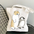 White canvas tote bag featuring cute cat and penguin illustration with shoulder handles - Cat and Penguin