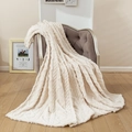 Solid cream white cable knit throw blanket with thick textured pattern on grey armchair - Off-white