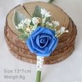 Elegant blue rose boutonniere for groom with white lace wrap and golden bead accents - Klein Blue