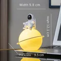 Astronaut on moon night light, yellow glowing sphere lamp for desk decor, 12cm height - Black Astronaut + Planet Lamp