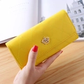 Detail of yellow quilted long wallet for women featuring golden crown snap fastener - Yellow