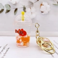 Macro view of a liquid-filled acrylic keychain with floating glitter and a clownfish toy - Orange (Milk Tea Clownfish)