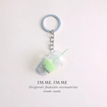 Macro detail of mini bubble tea keychain with green matcha liquid and striped straw - Light Green