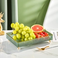 Green embossed glass fruit tray with gold rim and crystal legs on marble surface - Rectangular Tray Green
