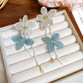 Close-up of woven fabric flower earrings with long beaded tassels and crystal drops - White Blue Woven Flower Long Tassel (Silver Earring Post)