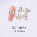 Detailed macro view of gold hollow knot nail charms with sparkling white rhinestones - Gold White Rhinestone Hollow Knot (8862)