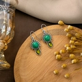 Detailed shot of retro silver earrings with turquoise and olive teardrop stone on wood - E5842-2-Retro Silver Turquoise Green Water Drop