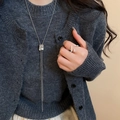 Detail of silver Y-shaped long necklace with sliding square pendant on a model - Silver Square Pleated Tassel Necklace