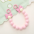 Dettaglio di perle rosa e fiocco con fibbie a molla metalliche circolari - Rosa