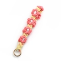 Pink daisy crochet wrist strap keychain with five floral charms and gold metal ring clasp - Watermelon red