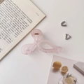 Detailed view of large pink bow hair claw clip with matte finish and gold spring - 11cm / Frosted Bow Pink