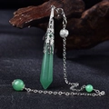 Detail of green crystal hexagonal pendulum with intricate silver filigree on dark wood - Silver Green Aventurine
