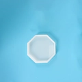 Translucent white octagonal silicone mold for DIY resin coasters on a blue background - Octagon Coaster Box Mold (10*10)