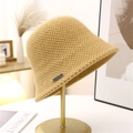 Chic yellow knit bucket hat for women in warm winter material on a display stand - M (56-58cm) / Camel