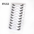 Detailed close-up of 10 pairs of cat-eye false eyelashes on a professional white tray - Curled Voluminous Style (XYJ12) / 10 Pairs Set
