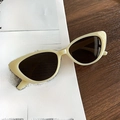 Retro cream cat-eye sunglasses with dark lenses displayed on a vintage wood surface - Jelly Green Frame Dark Grey Lens