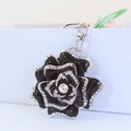 Elegant black enamel rose keychain with sparkling rhinestones and metal clip hardware - Black