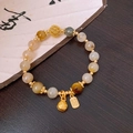 Detailed shot of Chinese style bead bracelet with a Fu character charm and gold bells - Retro Zen Fu Character Square Tag Style (32#)
