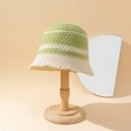 Green and cream striped knit bucket hat with wavy brim on a wooden display stand - M (56-58cm) / Beige & Green