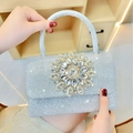 Silver glitter evening handbag with large crystal flower buckle and top handle - Silver