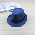 Classic dark blue jazz hat with black decorative ribbon on a minimalist wooden surface - One Size / Blue