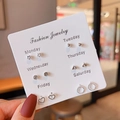 Detail of 6-pair weekly stud earring set featuring stars and hearts on a display card - Star Heart Ring Combination (E1280-1)
