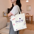 Off-white canvas tote bag featuring Starry Sky cosmic print and navy blue text - Happy Planet