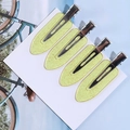 Set of four pale yellow glitter resin hair clips with metal duckbill base on white card - Crystal Yellow