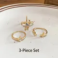 Three-piece golden ring set with star motifs, blue gemstone, and zircon accents - Gold (3-Piece Set)