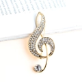 Elegante spilla a chiave di violino dorata con strass di cristallo scintillanti - Oro
