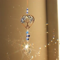 Macro view of crystal suncatcher casting rainbow light spots with a heart tree of life - Lapis Lazuli Heart