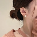 Detailed close-up of a heart-shaped gold earring with mother of pearl inlay on model - [XKE0197] White Shell Heart Studs Gold