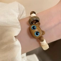 Ethnic style wooden bead bracelet with a blue-eyed cat charm on model wrist - Brown Log Carved Cat Bracelet