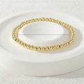 Detail of 4mm gold stretch metal bead bracelet showing 16-17cm circumference size specs - 4mm / Gold