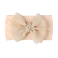Close-up of baby nylon headband with double-layered mesh bow in soft beige color - Nude Pink