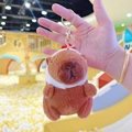Detailed close-up of brown plush capybara keychain with white scarf and gold metal clasp - Chick Hat Dark Brown + Gold Clip