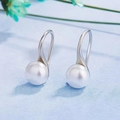Elegant white pearl drop earrings with polished silver hooks on a light blue background - S925 Sterling Silver / 8mm White Natural Pearl Earrings