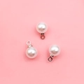 White spherical pearl pendant with silver metal cap on light pink background for DIY jewelry - 6mm Silver Round