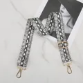 Close-up of adjustable python print bag strap with high-quality gold metal hardware - Python Pattern - Gold Buckle