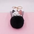 Detail view of a cute cartoon cat keychain with black pompom and gold hardware - (Gold Chain Clasp) / Black