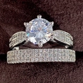 Luxury wedding ring set with round cut main stone and micro-paved bands in jewelry box - US 5 / White Gold