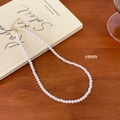 French vintage 6mm cream pearl necklace with gold clasp on a retro wooden table background - 6mm Pearl