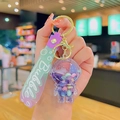 Astronaut liquid sand keychain with purple gradient silicone strap and golden hardware - Purple Quicksand Astronaut