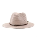 Close-up of woven straw fedora featuring a brown leather band and colorful metal buckle - Nude Pink
