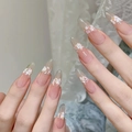 Detail of nude gradient almond press-on nails with delicate hand-painted white floral art - By1566 Is Dressed In Flamboyant Colors / Glue Type